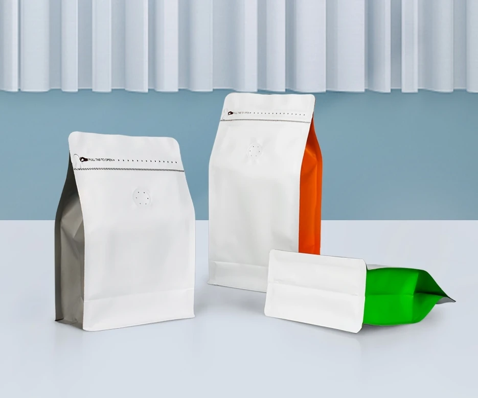 White flexible packaging bags with charcoal, orange and green side panels
